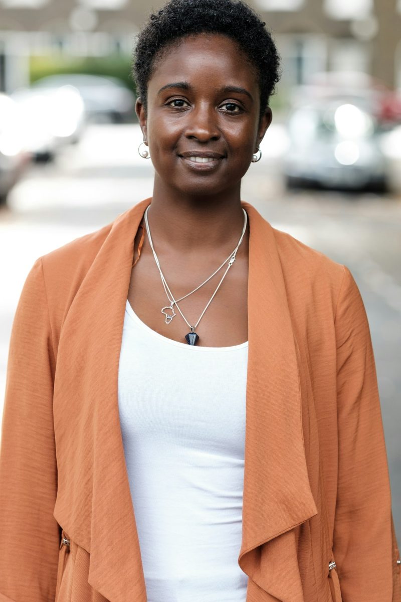 Black woman looking at camera in the street.