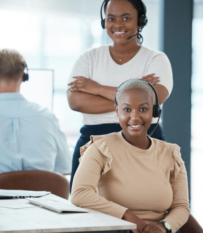 Happy, black woman and call center team smile in contact us, customer service or telemarketing at t